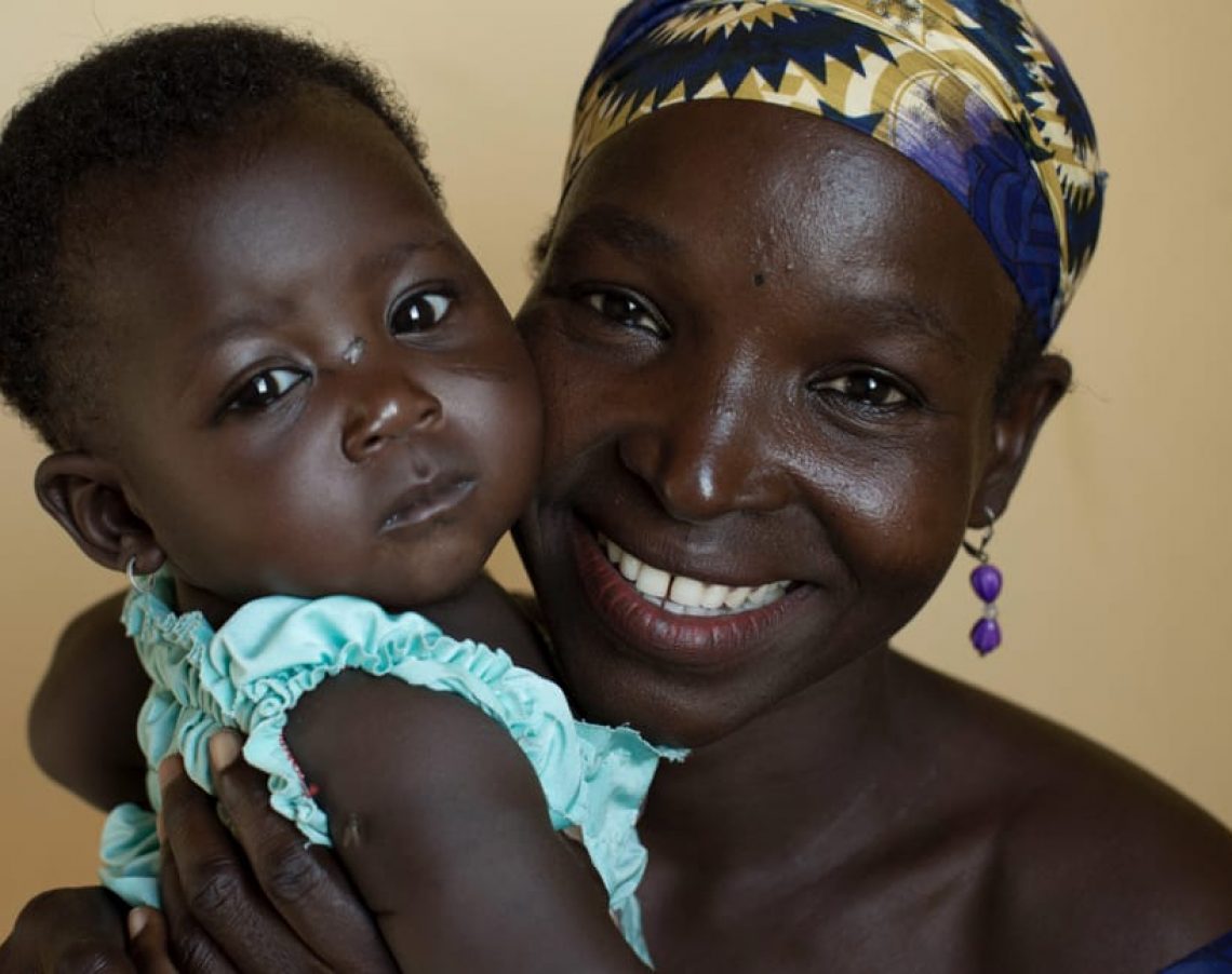 CARE/Josh Estey - Mother and child visiting one of the health centers supported by CARE.